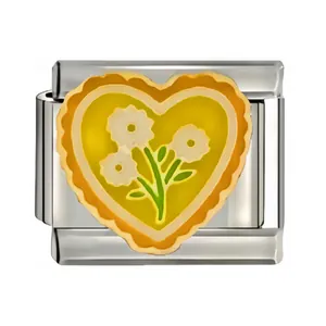 Detail macro view of stainless steel heart Italian charm with yellow flower design.