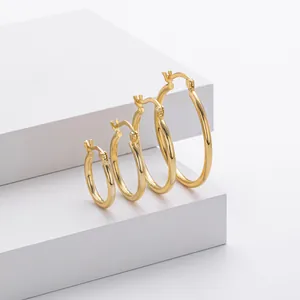 Polished gold S925 sterling silver hoop earrings set in four sizes on white blocks