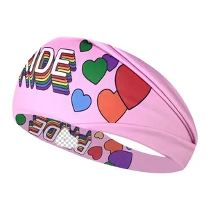 Close-up detail of a pink moisture-wicking sports headband with rainbow PRIDE text