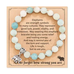 Macro detail view of the silver elephant charm on a beaded healing energy bracelet card