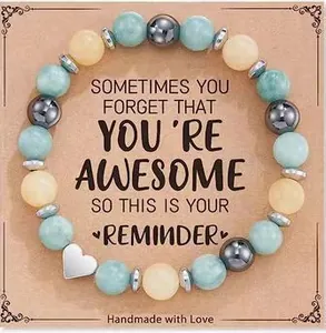 Detailed view of handmade beaded bracelet with heart charm and inspirational gift card