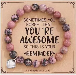 Pink zebra stone beaded heart charm bracelet presented on a motivational gift card