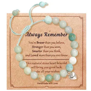 Detailed view of handmade natural stone bead bracelet with silver heart charm and gift card