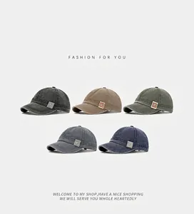 Detailed display of five washed canvas baseball caps in vintage shades with short brims