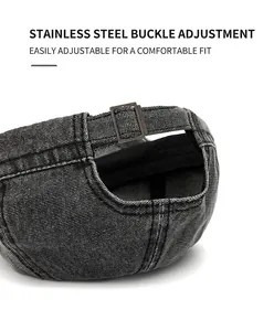 Close-up of the adjustable stainless steel metal buckle on a washed canvas cap.