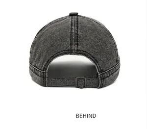 Detailed rear view of washed black canvas baseball cap with adjustable metal buckle strap