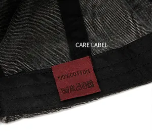 Close-up view of the 100% cotton care label on a washed canvas baseball cap's inside.