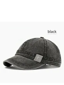 Detailed view of a vintage black washed canvas baseball cap with a unique short brim