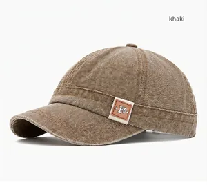 Close-up detail of a khaki washed canvas baseball cap with short brim