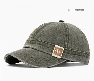 Side view detail of army green washed canvas baseball cap with short brim and logo