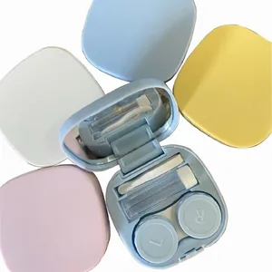 Portable pastel contact lens storage case set with built-in mirror and accessories.