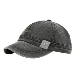 Premium vintage washed canvas baseball cap featuring a short brim and logo patch