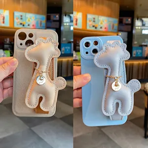 Close-up of two cute cartoon giraffe wristband phone cases in beige and light blue