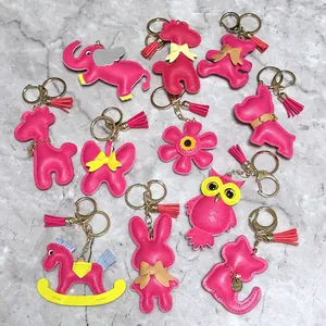 Collection of various pink leather animal bag charms with tassels and gold keyrings.
