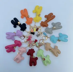 Colorful cartoon giraffe leather bag charms with tassels in a circular arrangement