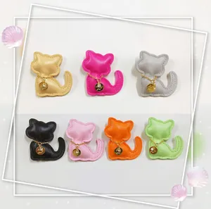 Detail view of colorful cat-shaped faux leather charms for phone cases and bags