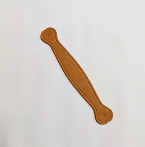 Detailed macro view of a brown textured synthetic leather wrist strap for phone cases