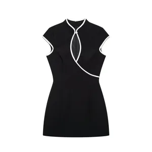 Detailed view of an elegant black new Chinese style Qipao dress with white piping.