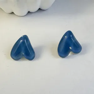 Blue heart-shaped resin stud earrings with a glossy cat-eye stone finish for women