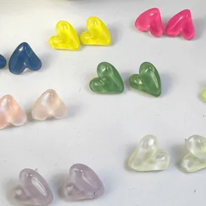 Vibrant selection of candy-colored heart-shaped resin stud earrings on a white surface