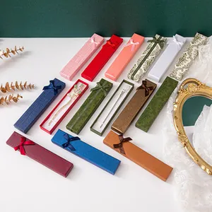 Multiple colors and patterns of rectangular jewelry gift boxes with elegant silk bow ties