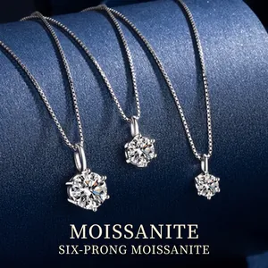 Macro detail of three silver moissanite necklaces with elegant six-prong settings