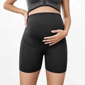 Detail shot of high-waisted black maternity shorts featuring belly support design