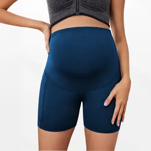 Navy blue high-waisted maternity yoga shorts with belly support for pregnancy workout.