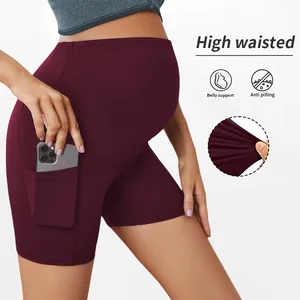 Detail of burgundy maternity yoga shorts with phone pocket and belly support
