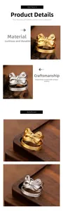 Close-up of gold and silver stainless steel rings with a stylish bow design