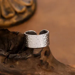 Minimalist stainless steel wide band ring with hammered texture and adjustable open design