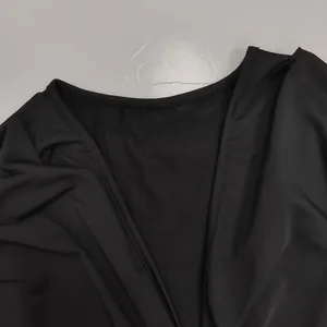Detailed view of the elegant V-neckline and fine stitching on this black sexy dress