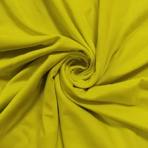 Close-up detail of mustard yellow ribbed fabric texture for a sexy spring cutout dress
