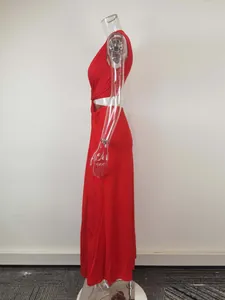 Side view of a sexy red sleeveless maxi dress with waist cutout and knot detail.