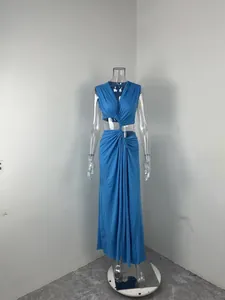 Sleeveless blue maxi dress with twist detail and waist cut-out on a clear mannequin.