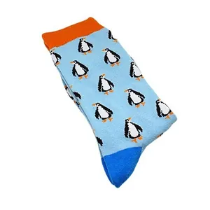 Soft cotton mid-calf socks featuring a cute repeating penguin pattern on light blue