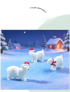 Close-up of white polar bear figurines with Santa hats in snowy micro landscape