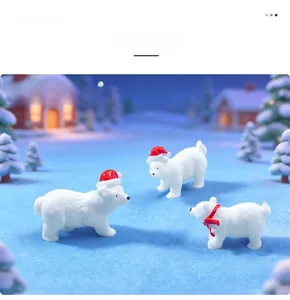 Group of three miniature Christmas polar bear figurines set in a snowy landscape