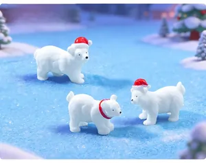 Detailed view of cute Christmas polar bear figurines in a snowy micro-landscape.