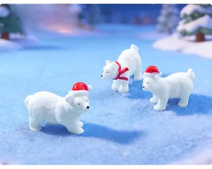 Macro detail of three miniature Christmas polar bears wearing festive red hats and scarf