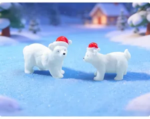 Close-up of adorable white polar bear miniatures with red Santa hats in a snow scene