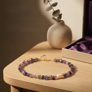 Detailed view of hand-strung amethyst chip necklace with a freshwater pearl accent