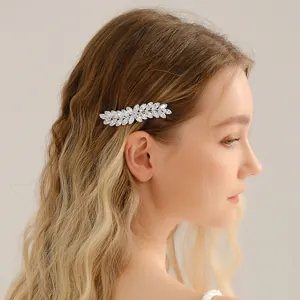 Barrette en zircone avec motif de feuilles élégante portée sur cheveux blonds ondulés