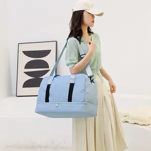 Large capacity light blue travel bag with dry-wet separation carried by Asian model