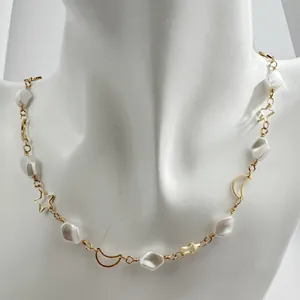 French retro gold necklace featuring irregular white beads with star and moon charms