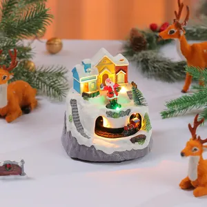 Festive Christmas resin music box featuring a rotating train and glowing LED lights