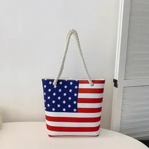 Fashionable large capacity canvas tote bag featuring an American flag design with rope handles.