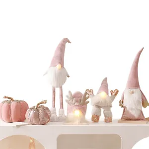 Cute pink faceless Christmas gnome ornaments with LED glowing noses for home decor