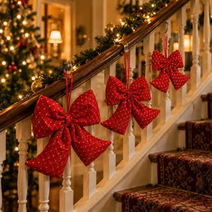 Detailed view of red padded Christmas bow ornaments with gold dots on a staircase