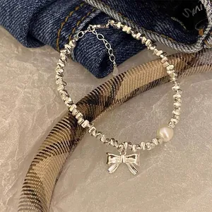 Elegant S925 sterling silver bracelet featuring irregular beads, a pearl and a bow charm